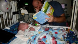 Daddy reading some bedtime lullabies before going to sleep.